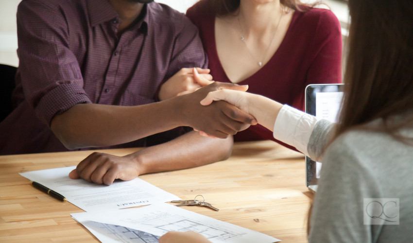 shaking hands with home design clients as an interior decorator