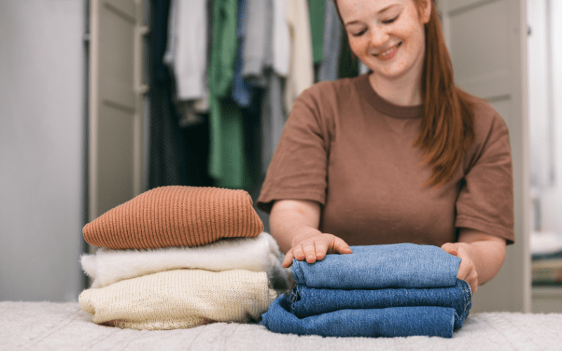 how to become a professional organizer - woman folding clothes