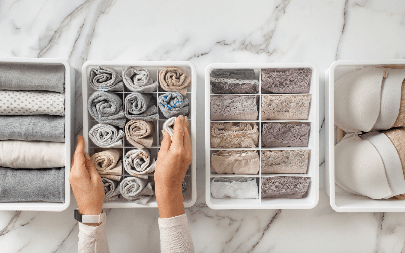 professional organizer organizing clothes into small bins