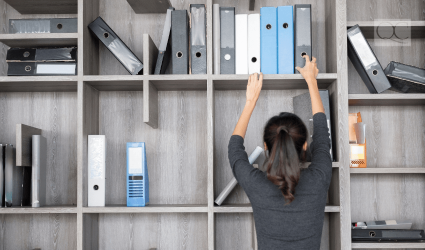 professional organizer organizing corporate bookshelf