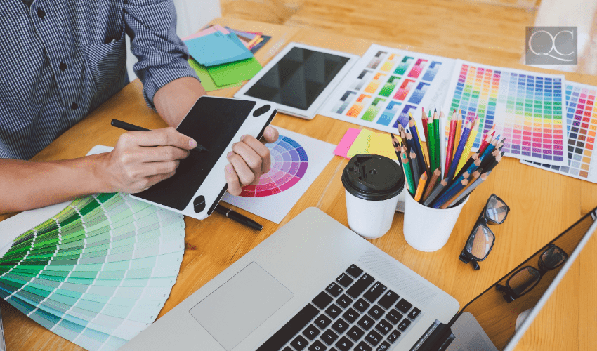 designers working at desk on laptop