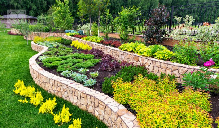 Landscape design of nice home garden, natural landscaping with decorative stones in residential house backyard. Luxury flowerbed and beautiful landscaping in summer, green landscaped yard.