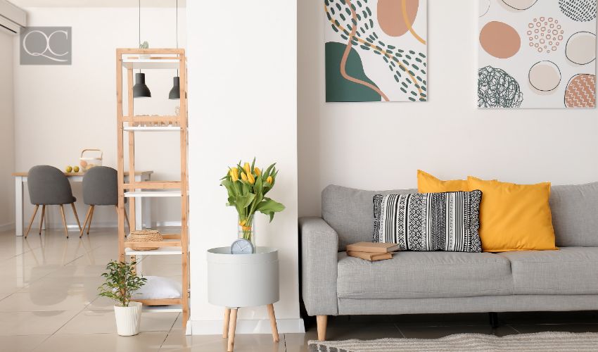 Interior of modern room with comfortable sofa and table with spring flowers