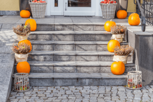 curb appeal exterior of home in fall - pumpkins on stairs