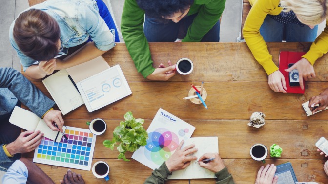 People sitting around a table participating in a design workshop