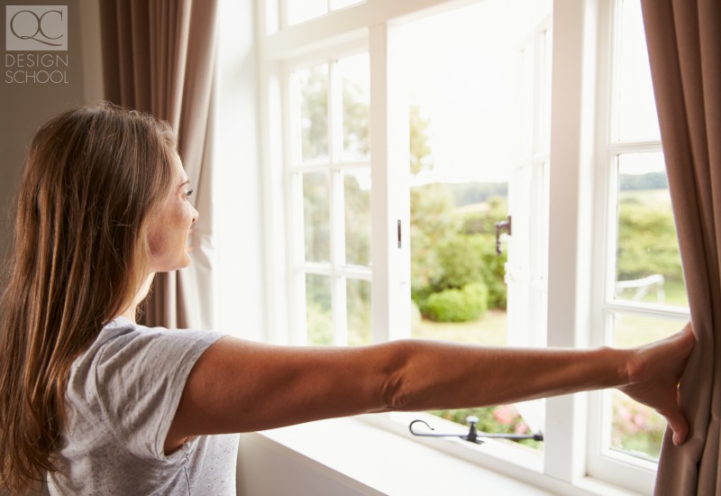 girl opening window for fresh air