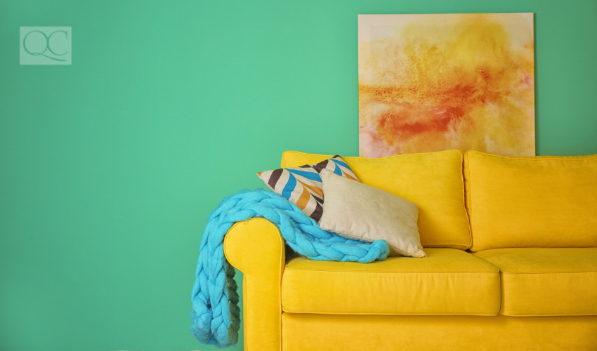 Color coordinated couch with throw blanket and painting