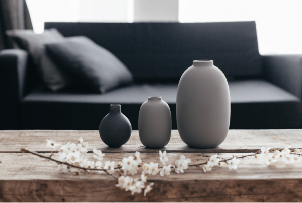 minimalistic grey and black pot decor on wooden coffee table