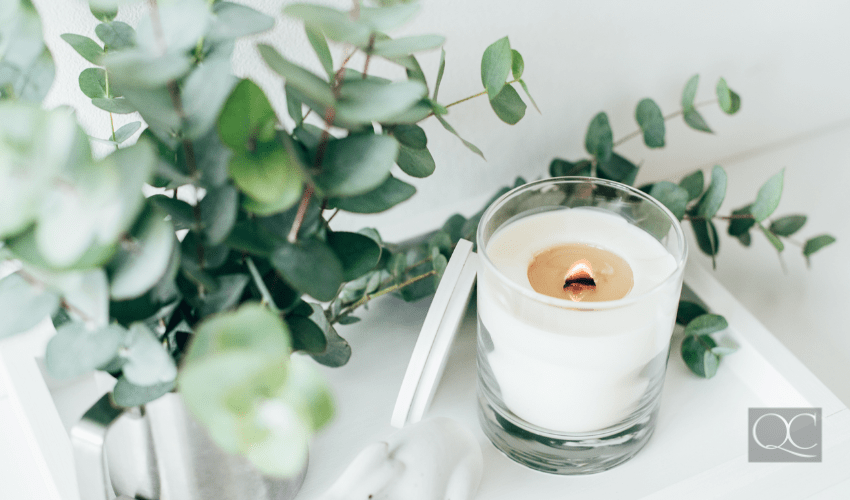 Natural eco home decor with green leaves and burning candle on it