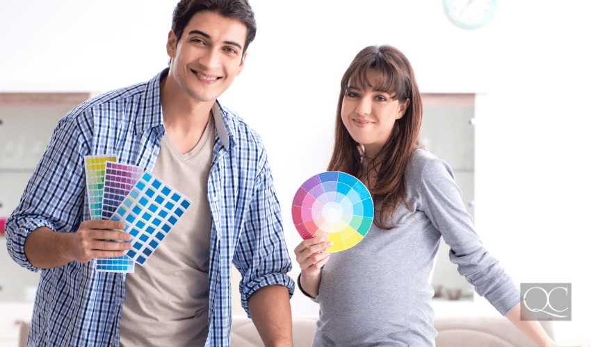 Young parents expecting their first baby, choosing colors for nursery room