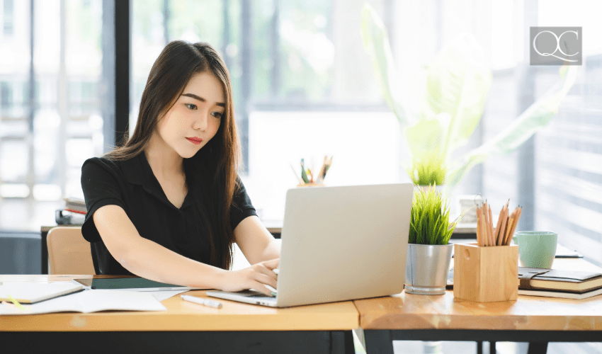 interior designer working at desk on laptop