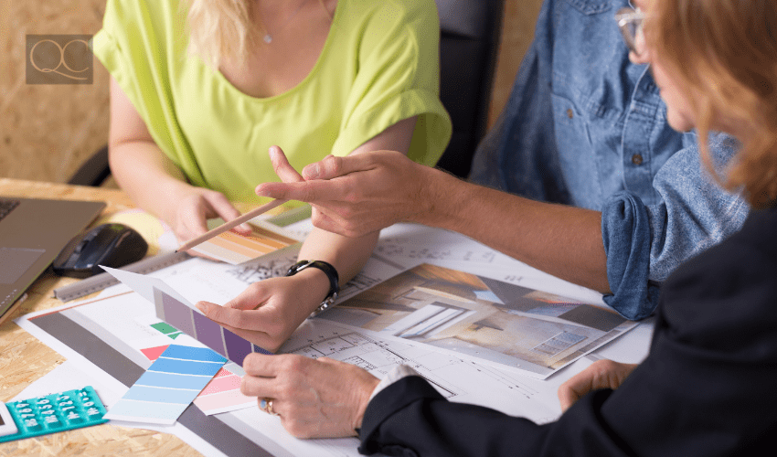 designer with clients, sitting at table