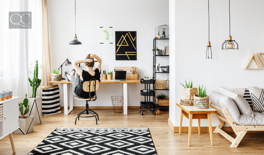 Woman lounging in apartment on laptop