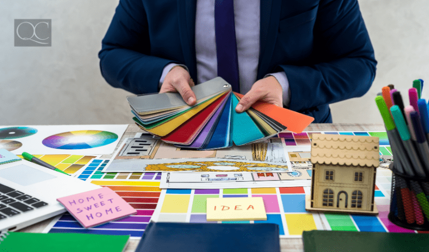 Male designer at desk, holding out color swatches