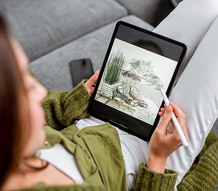 Woman digitally sketching backyard landscape design