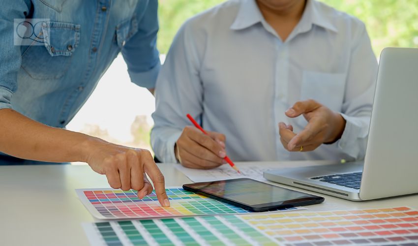 Graphic design and color swatches and pens on a desk. Architectural drawing with work tools and accessories