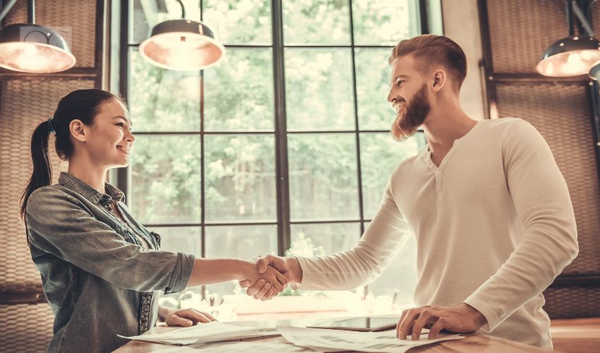 Man and woman shaking hands, collaboration and networking concept.