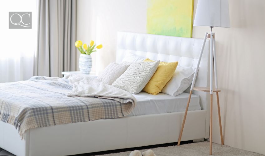 Bedroom interior in light tones with white furniture and pictures on the wall