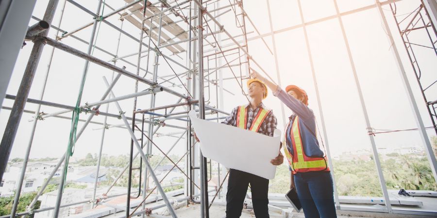 Engineers are meeting and pointing to new construction sites, Engineering tools and construction concept. Designers working with contractors article.